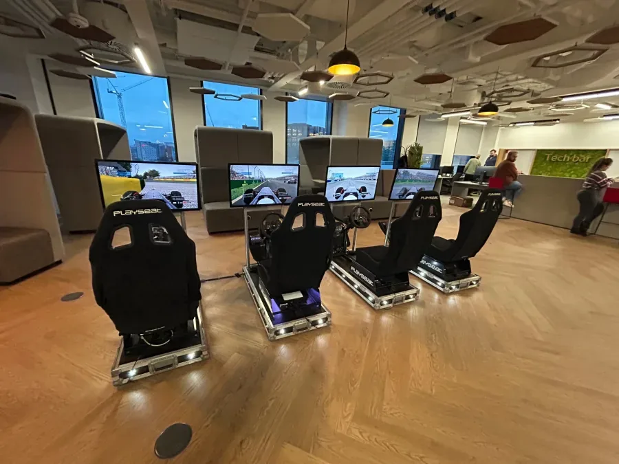 Four F1-style simulators at an office staff day
