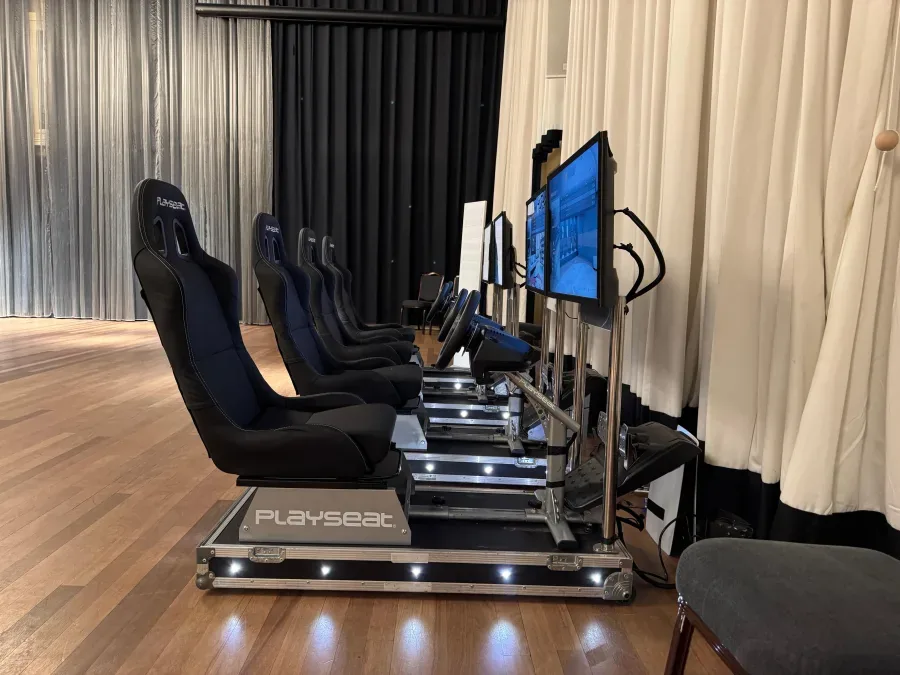 Racing simulators lined up in a hotel ballroom